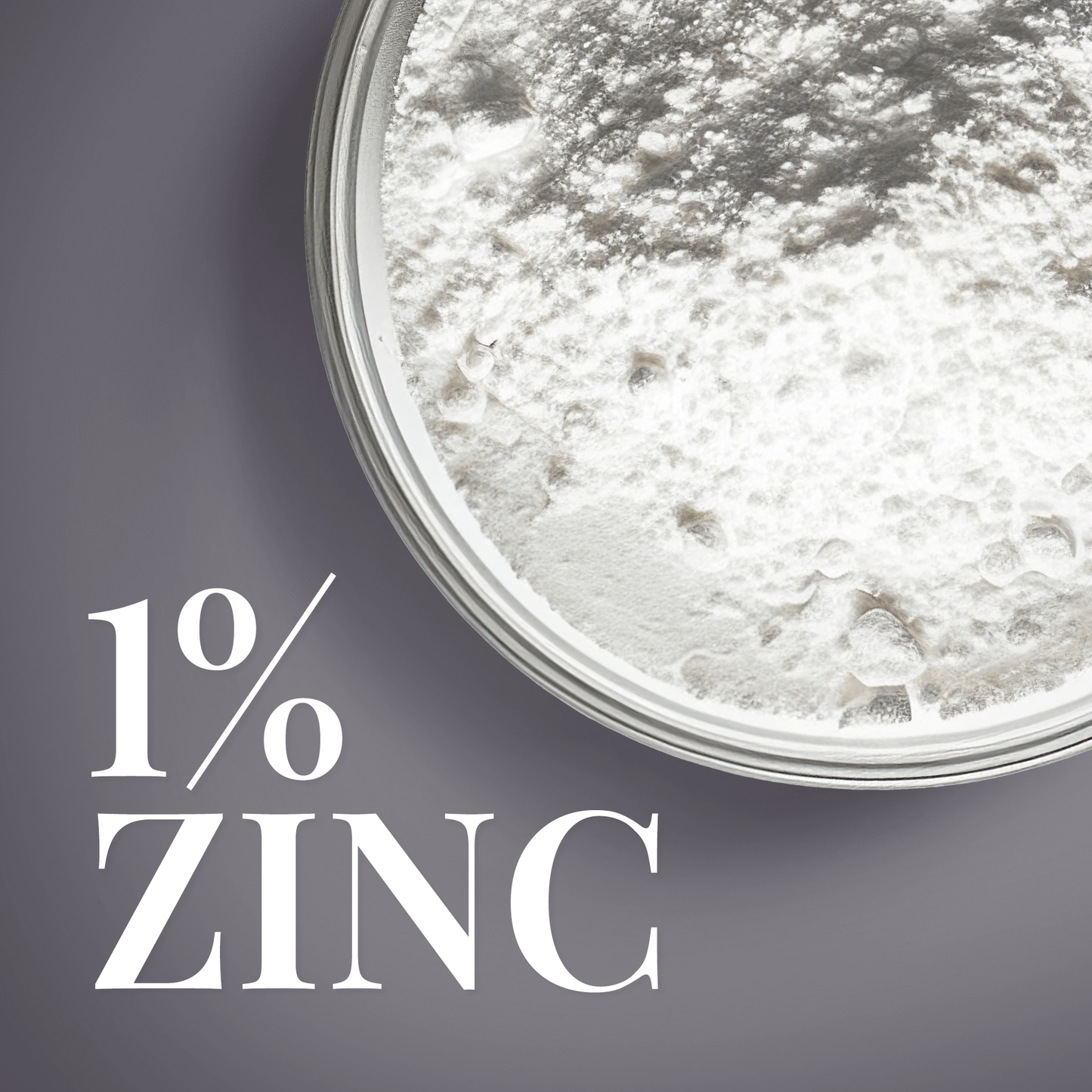 Close-up of 1% zinc powder texture in a glass dish, promoting skincare benefits.