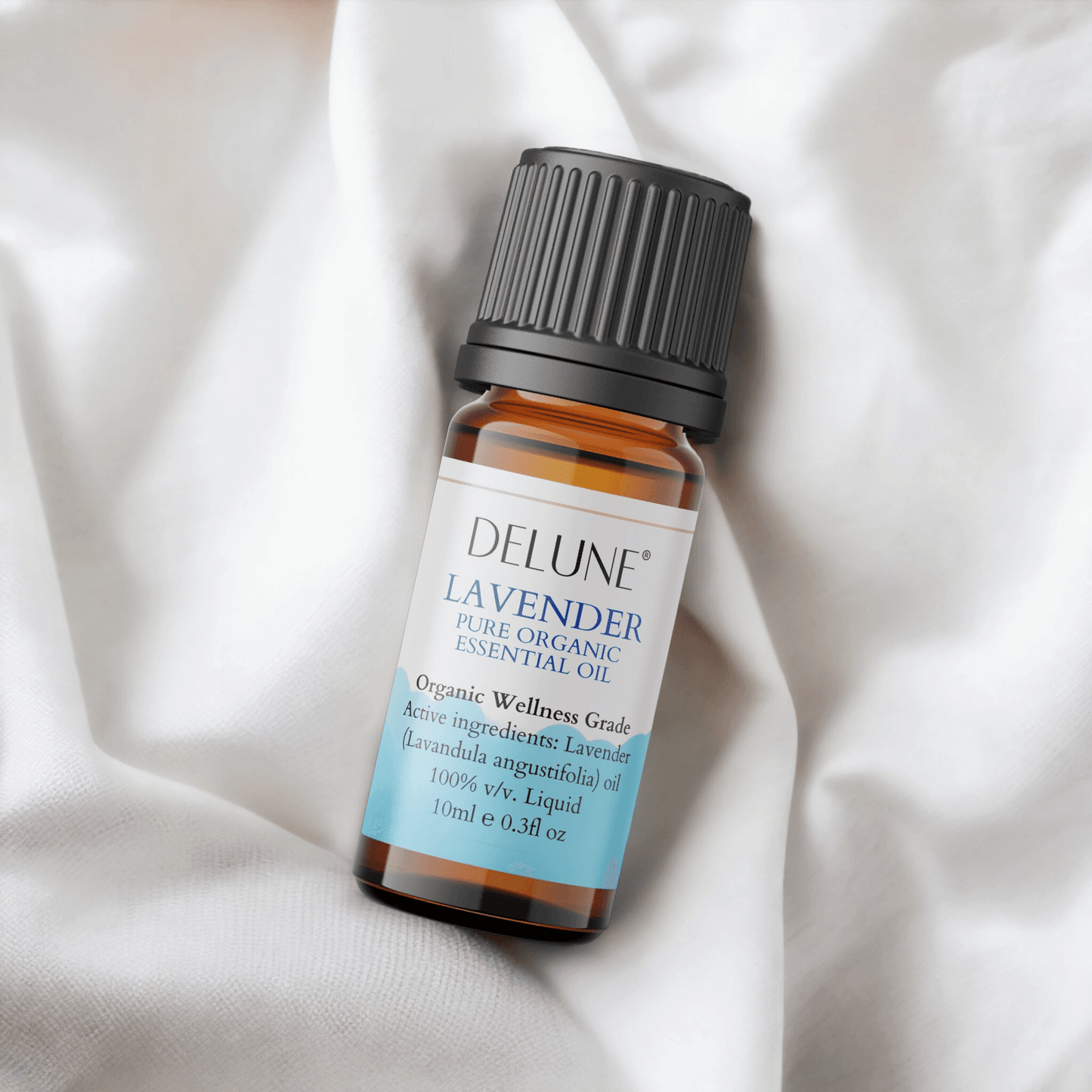 Glass bottle of Delune Lavender Organic Wellness Grade Essential Oil, 10ml, with a calming aroma, on a soft white fabric.
