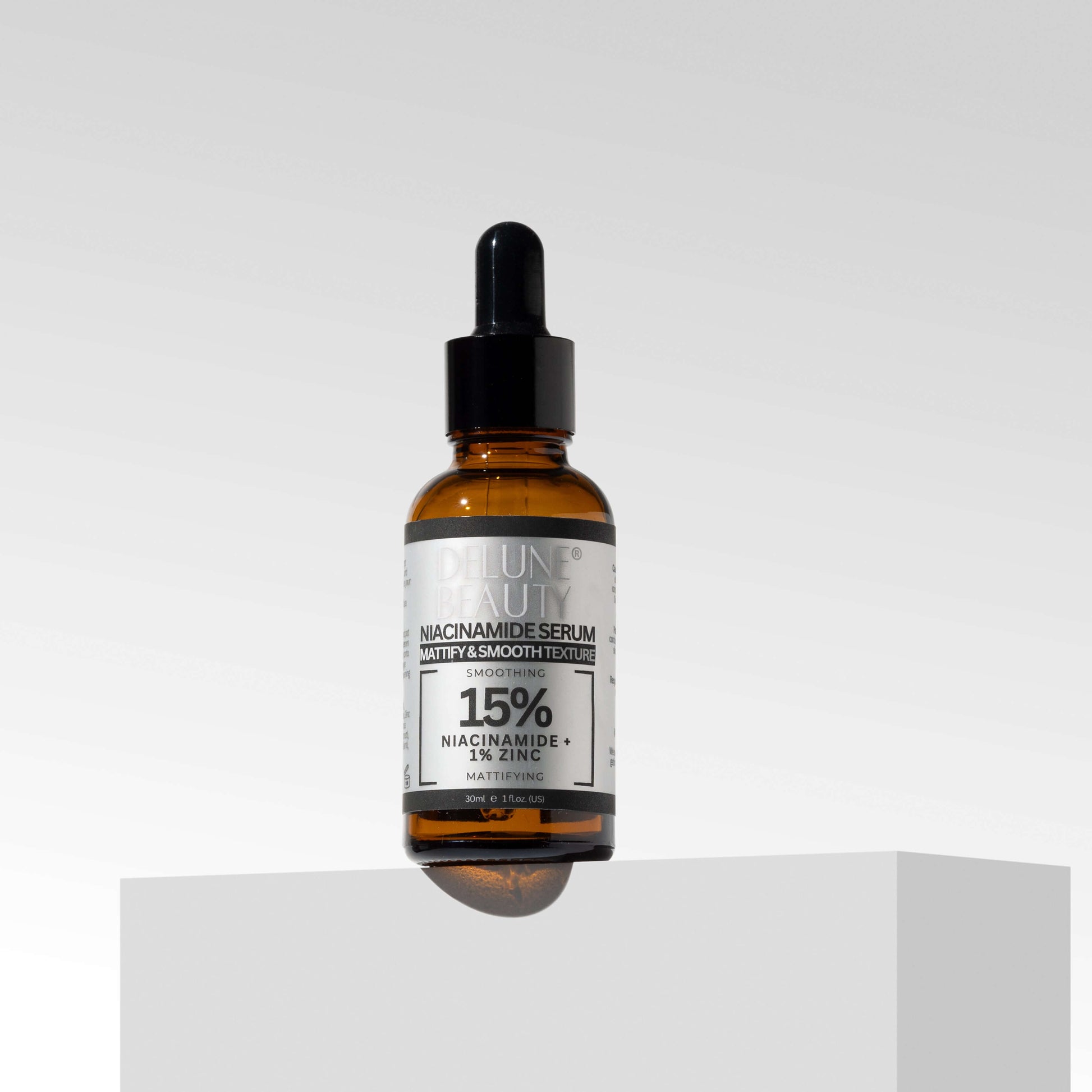 Niacinamide and 1% Zinc Serum bottle for blemishes with 15% niacinamide formula on a minimalist pedestal.