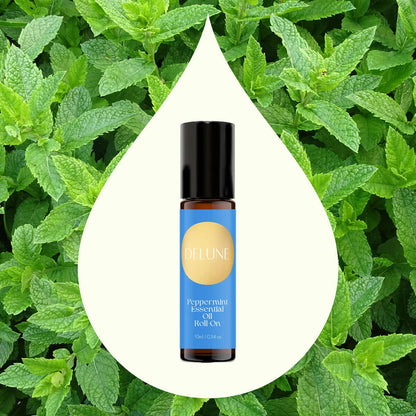 Peppermint Essential Oil Roll-On by Delune on fresh mint leaves background. Invigorating peppermint aroma for mental clarity.