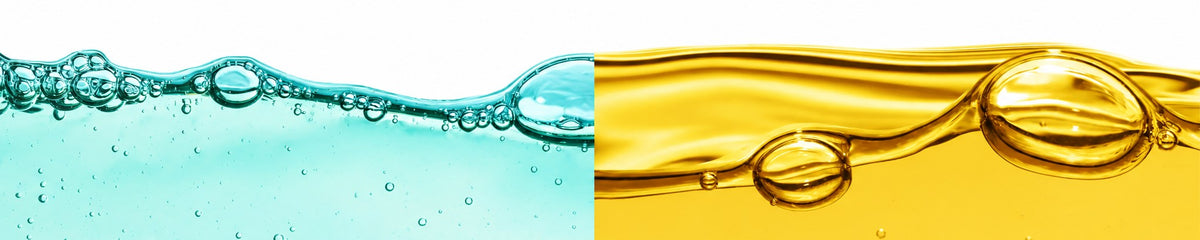 Clear water and golden essential oil meeting side by side