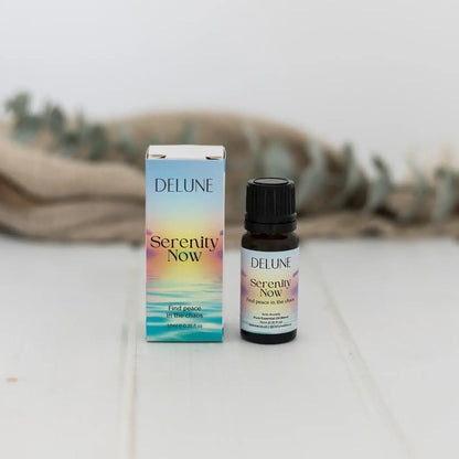 Serenity Now essential oil blend bottle and box promoting anti-anxiety and relaxation benefits with floral and grounding scents.