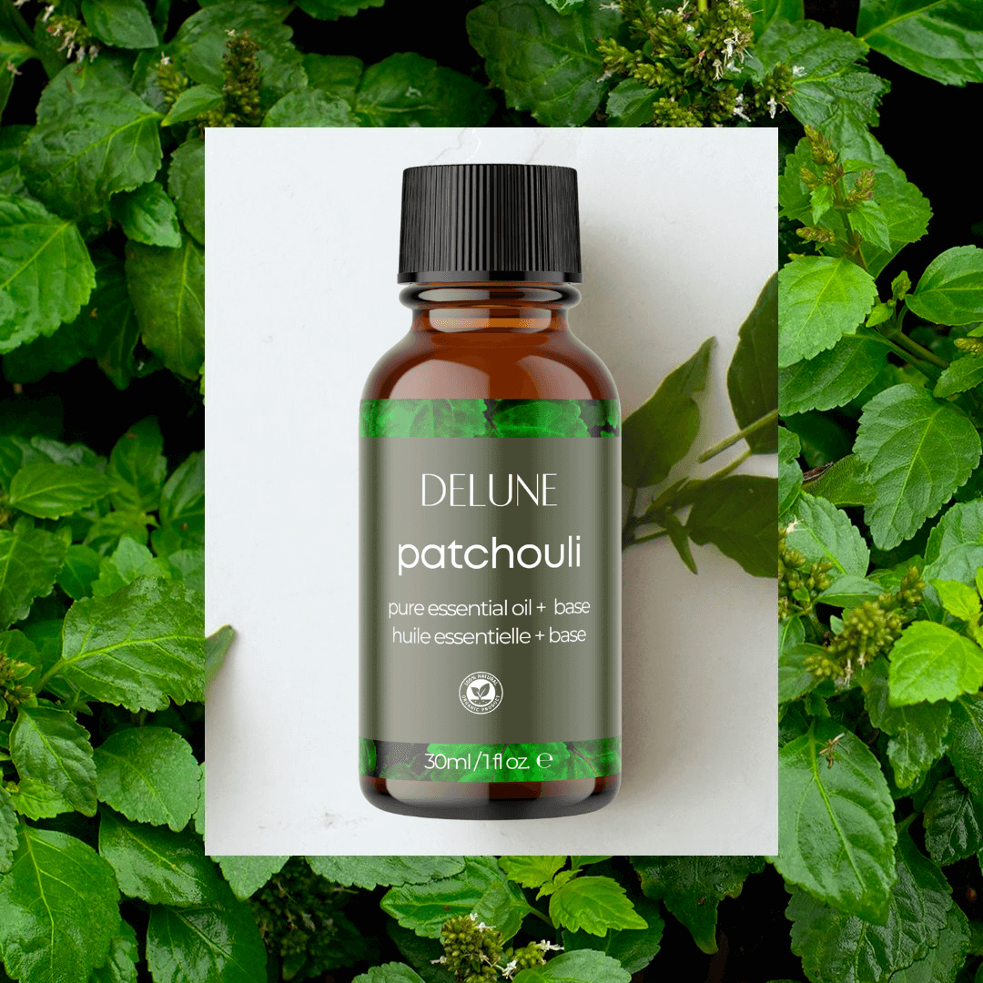 Patchouli Essential Oil bottle with lush green leaves background, showcasing calming woodsy aroma perfect for body and bath relaxation.